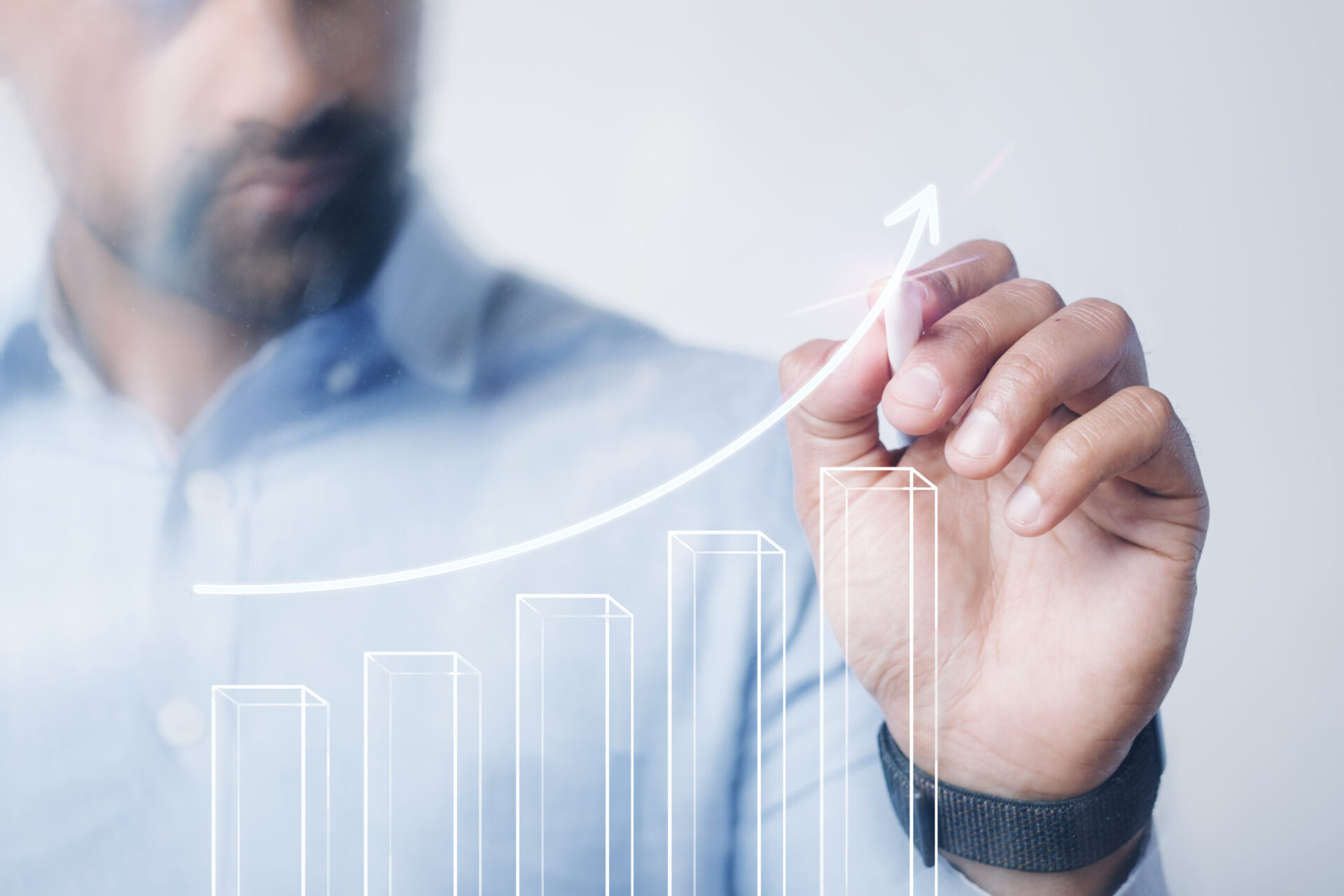 Businessman drawing a growing bar chart with arrow | Webface