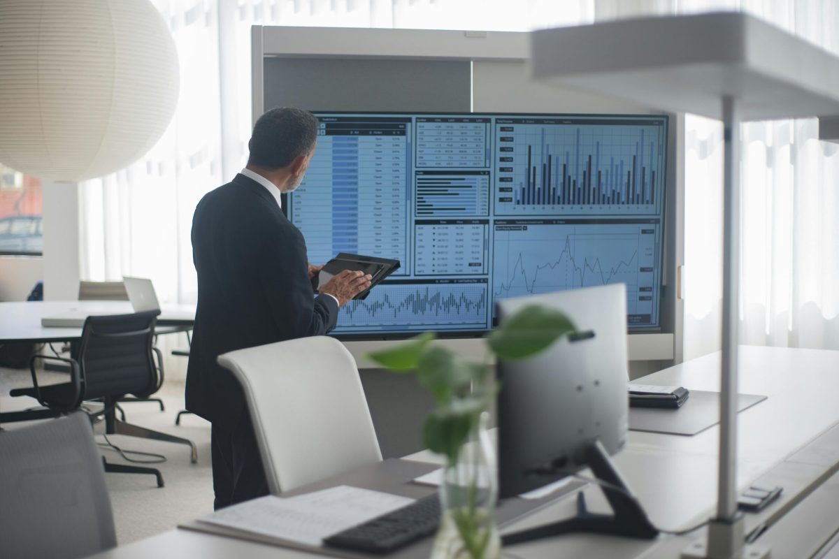 Businessman analyzing enterprise data dashboard | Webface