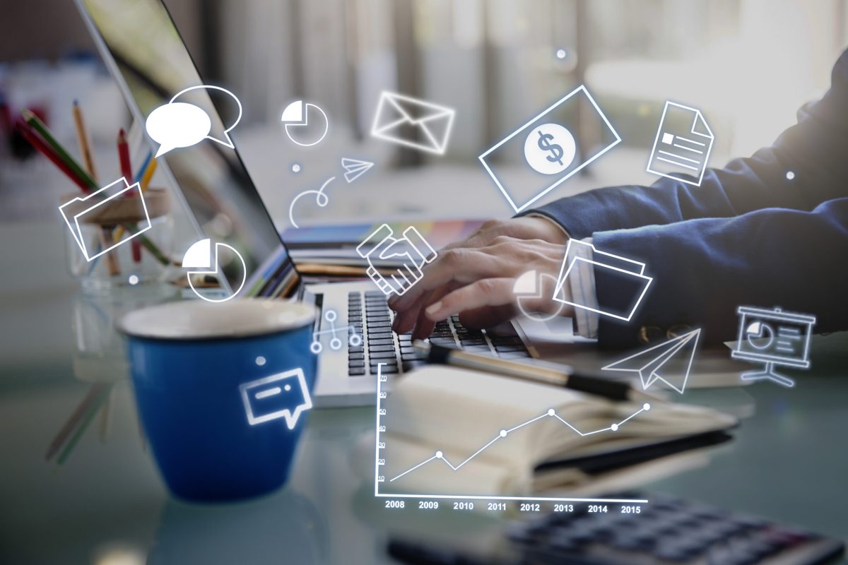 Business professional typing on a laptop with floating digital marketing and strategy icons representing online marketing services | Webface