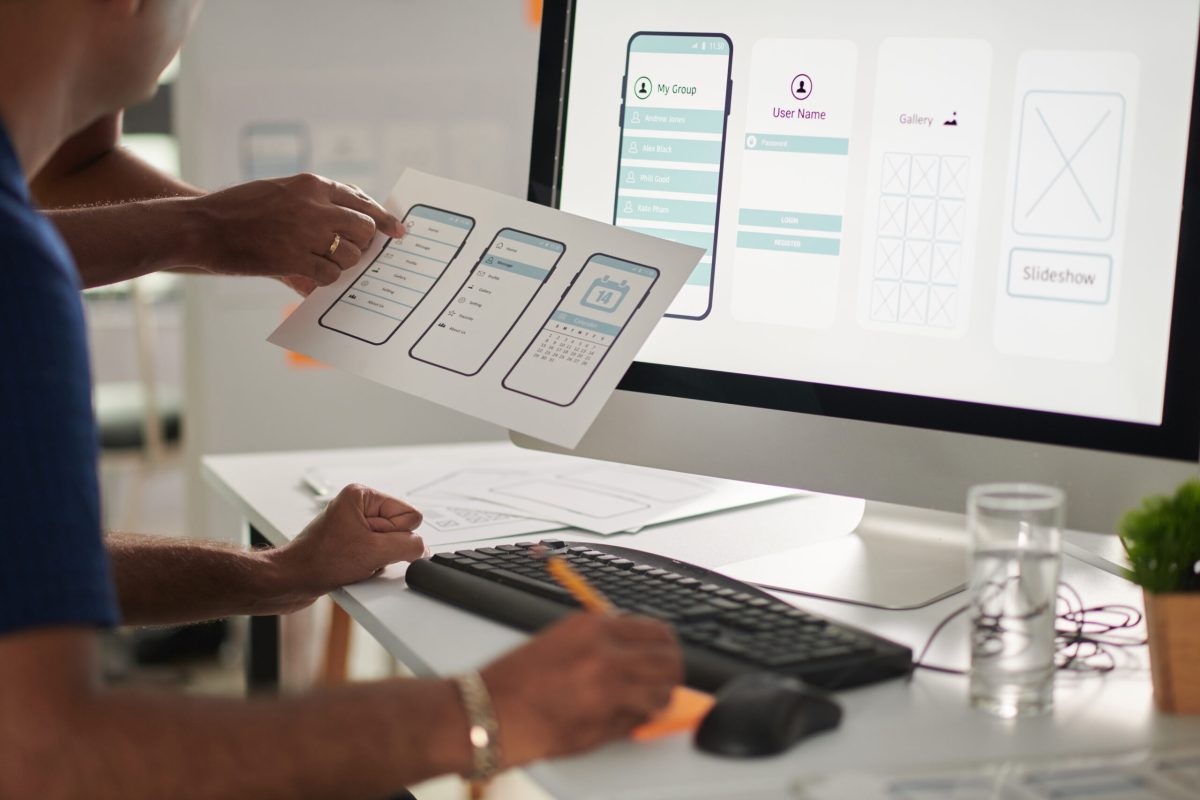 Designers working on web application interface and user experience design with wireframes and desktop screen | Webface